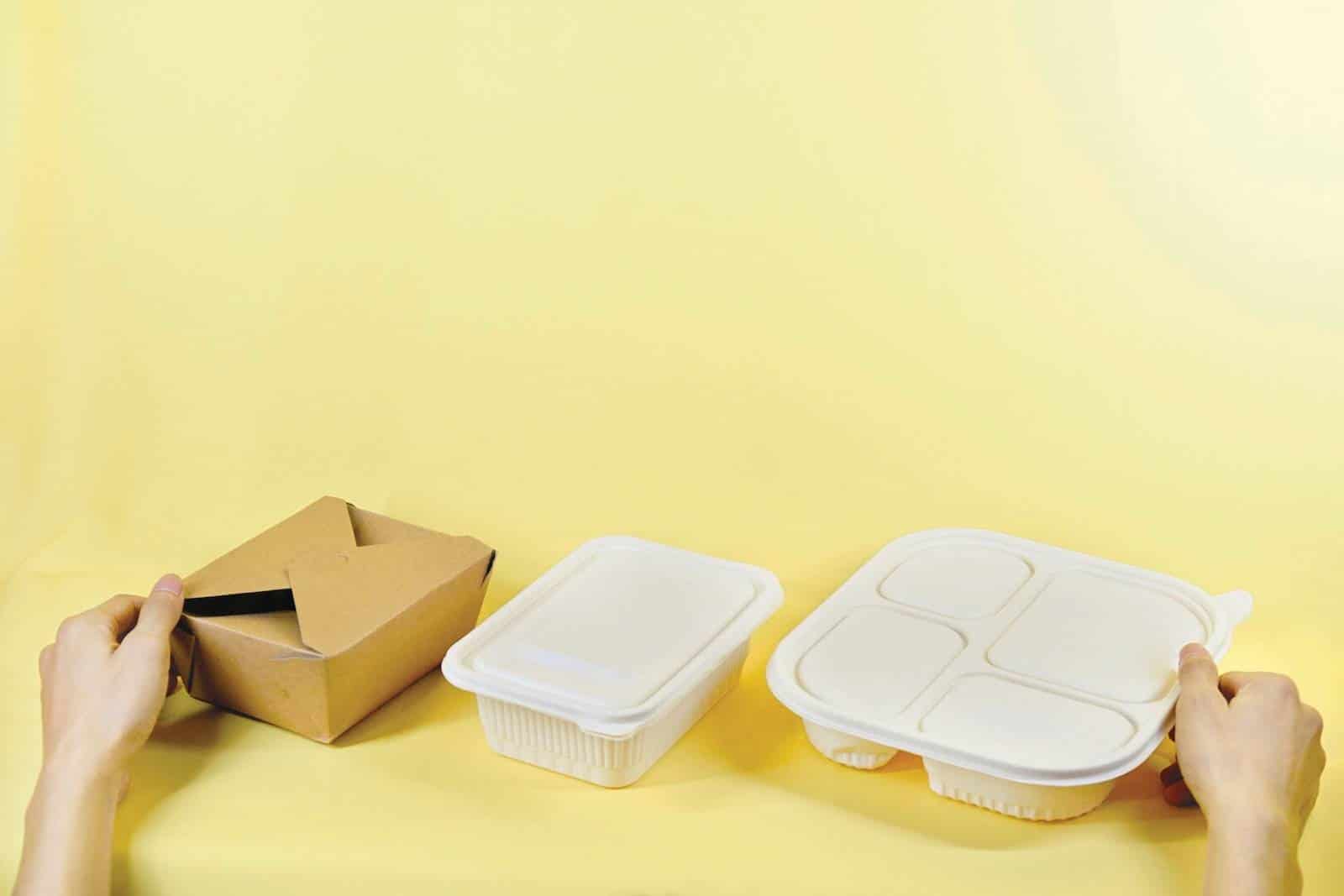 sustainable home food packaging a person holding a box and two take out containers